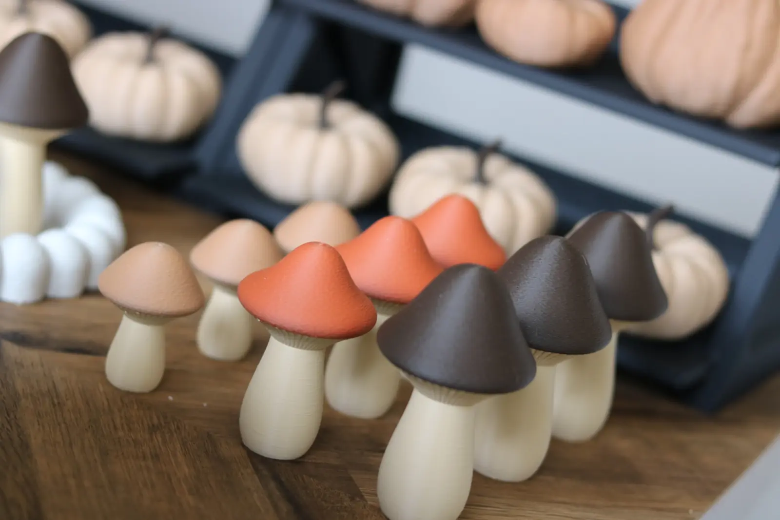 Small mushroom figures with orange, brown, and tan caps.